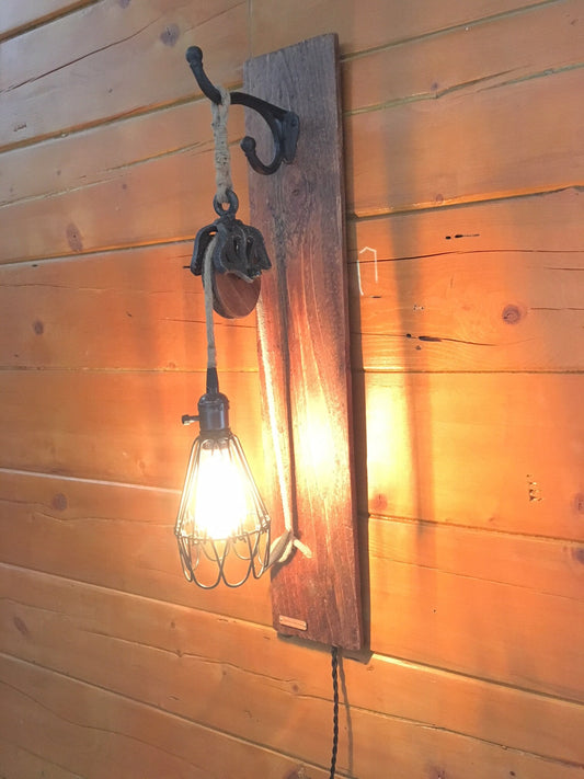 Wall sconce with metal pulley for country decor, cabin chic light fixture adds rustic charm, ideal blend of industrial and farmhouse vibe
