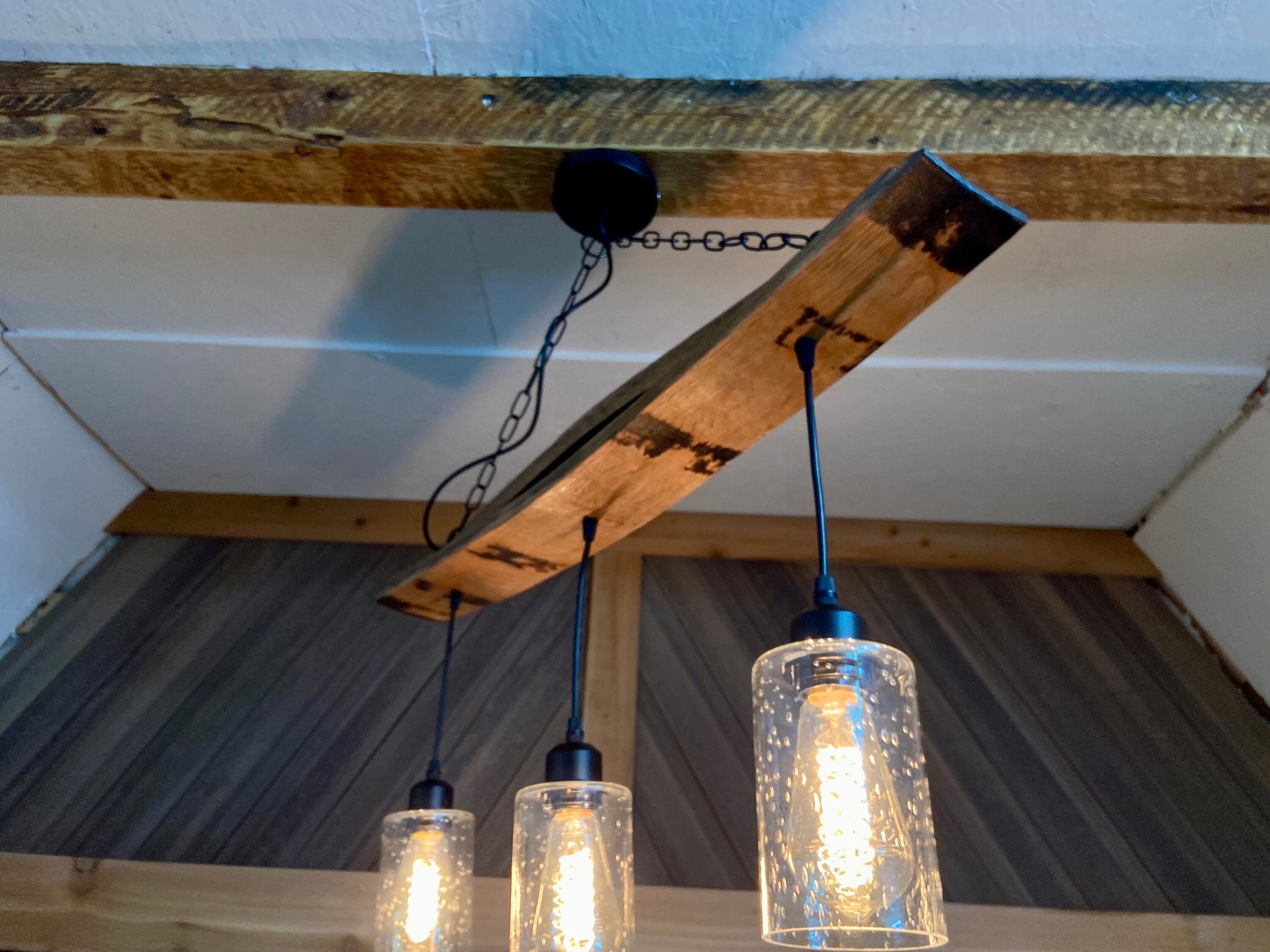 Unique ceiling pendant light from authentic bourbon barrels staves, ideal for bar or man cave, adds warmth and character