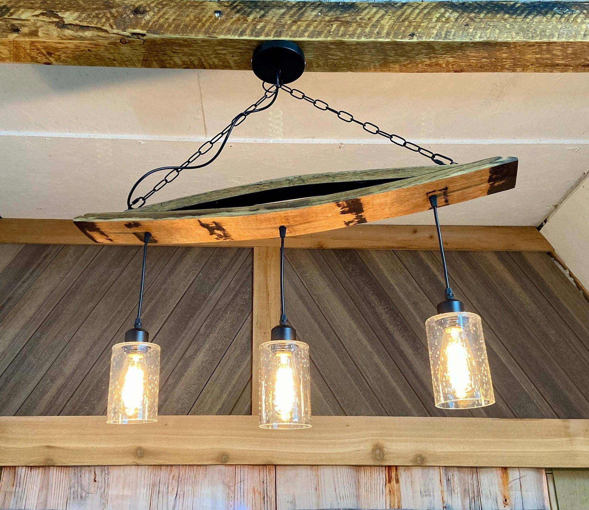Unique ceiling pendant light from authentic bourbon barrels staves, ideal for bar or man cave, adds warmth and character