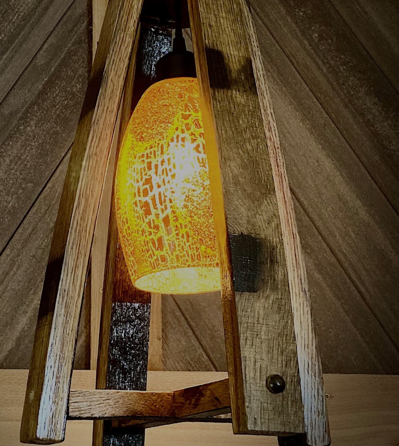 Handcrafted light fixture made from genuine barrel saves, accentuated by warm amber glass shade, perfect blend of rustic and elegance