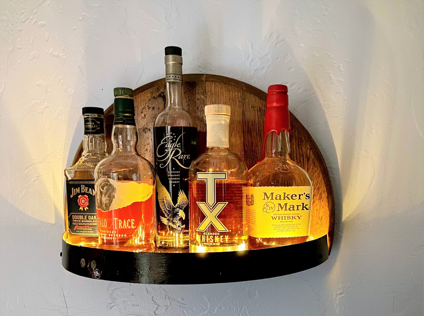 Illuminated whiskey barrel liquor display shelf perfect for displaying your bar collection, handcrafted from Kentucky bourbon barrel