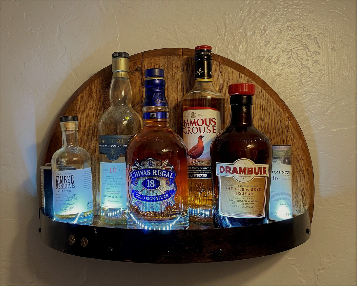 Illuminated whiskey barrel liquor display shelf perfect for displaying your bar collection, handcrafted from Kentucky bourbon barrel