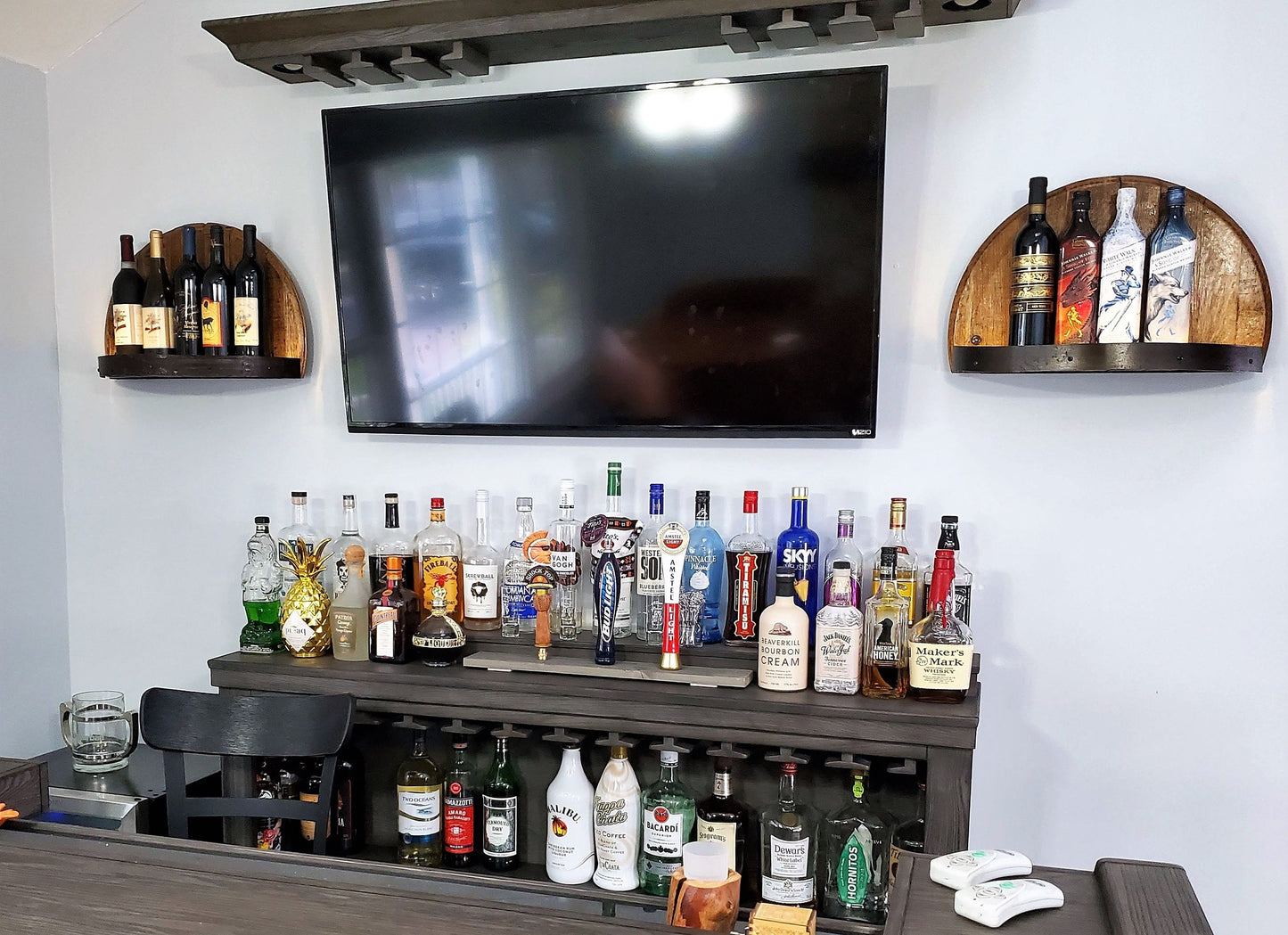 Illuminated whiskey barrel liquor display shelf perfect for displaying your bar collection, handcrafted from Kentucky bourbon barrel