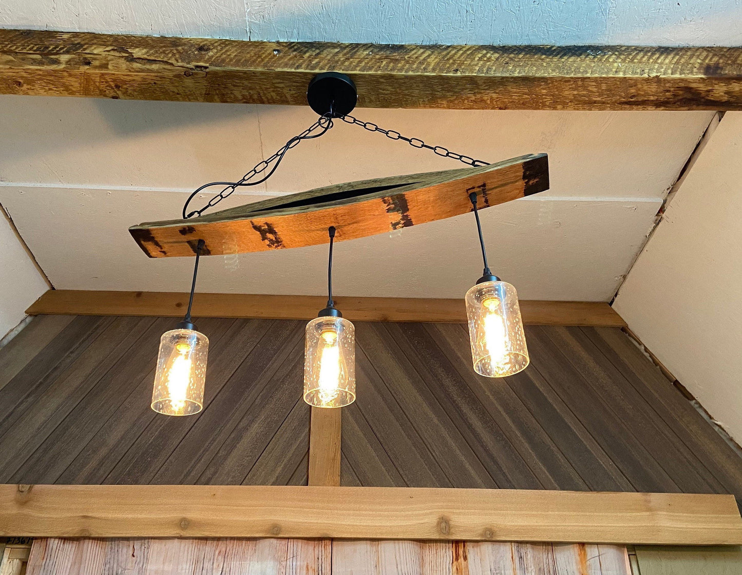 Unique ceiling pendant light from authentic bourbon barrels staves, ideal for bar or man cave, adds warmth and character
