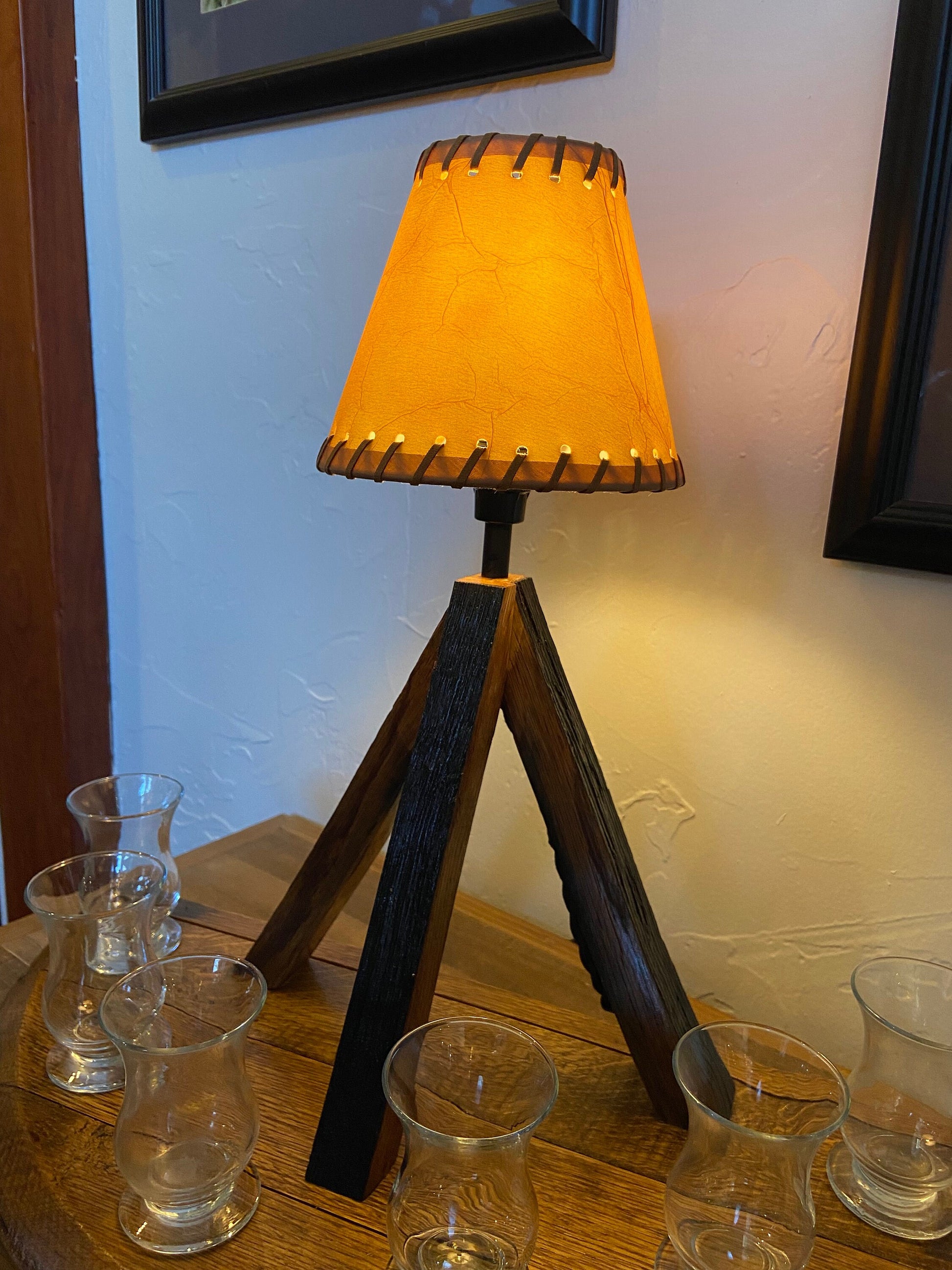 Whiskey barrel table lamp with leather shade mounted on barrel lid, perfect for the bar or mancave using genuine Kentucky bourbon barrels