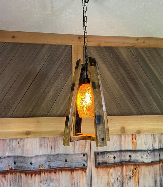 Handcrafted light fixture made from genuine barrel saves, accentuated by warm amber glass shade, perfect blend of rustic and elegance