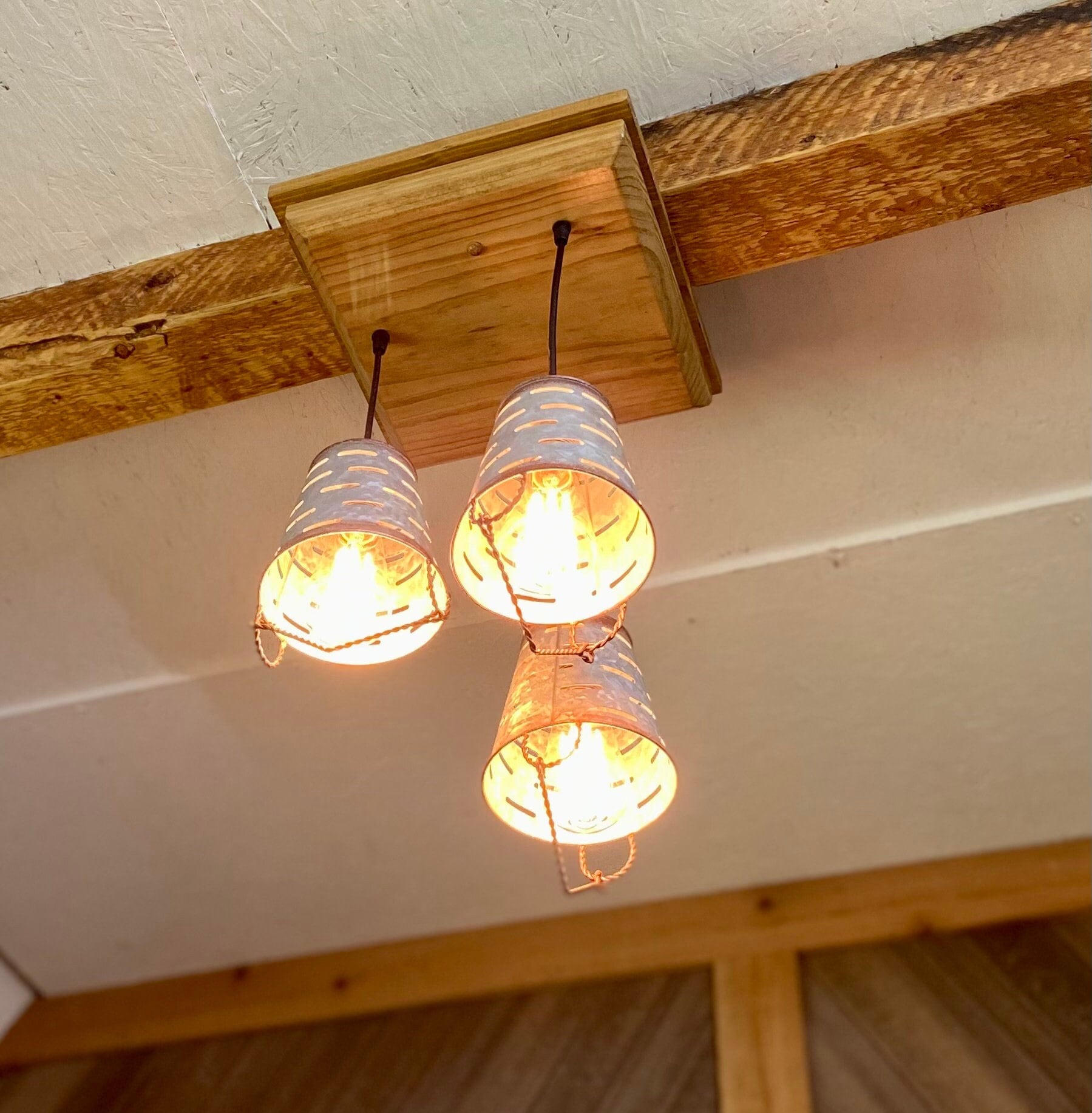 Rustic farmhouse three light fixture with olive bucket shades, wooden ceiling pendant with 3 galvanized metal bucket lights for cabin decor
